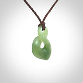 Hand carved small New Zealand Inanga jade twist pendant.